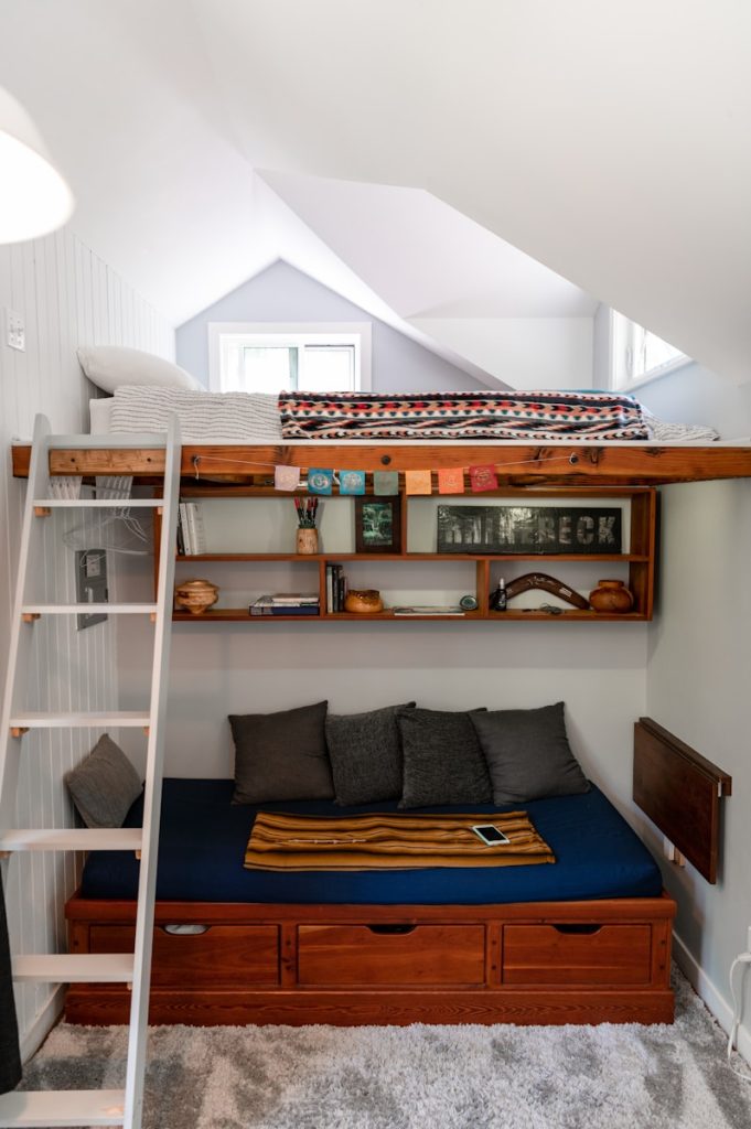 a loft bed with a ladder to the top of it